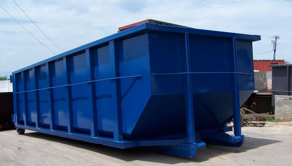Large blue dumpster in a yard