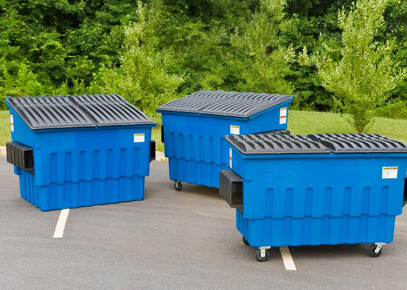 three blue dumpsters on wheels