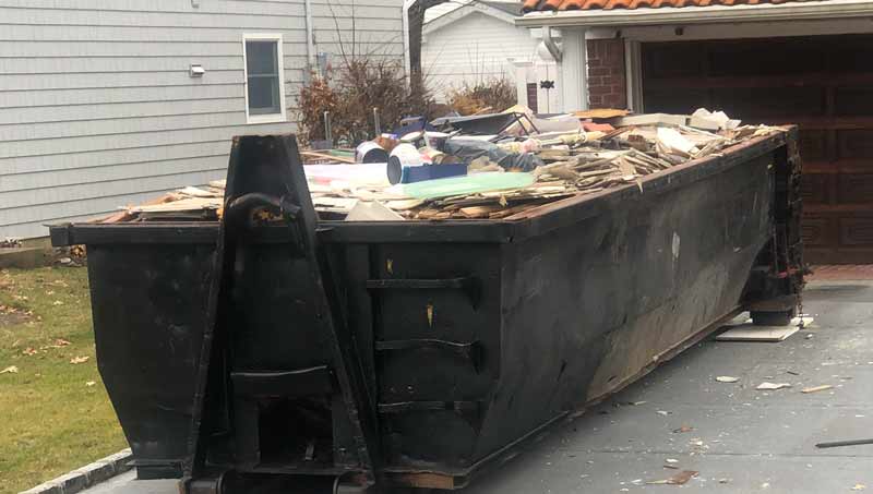 roll off dumpster filled to the top with trash