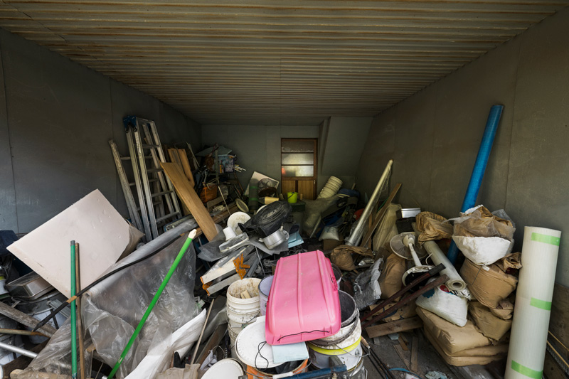 Garage house interior filled with clutter in need of junk removal