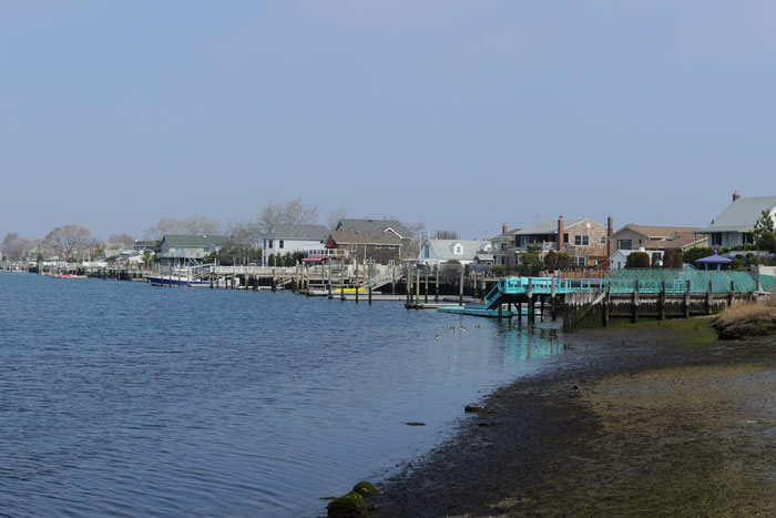 Baldwin Bay from Waterfront Park, Freeport, Long Island, New York. House at left is on a small island in Freeport. Houses in the distance are variously in Freeport and Baldwin Harbor